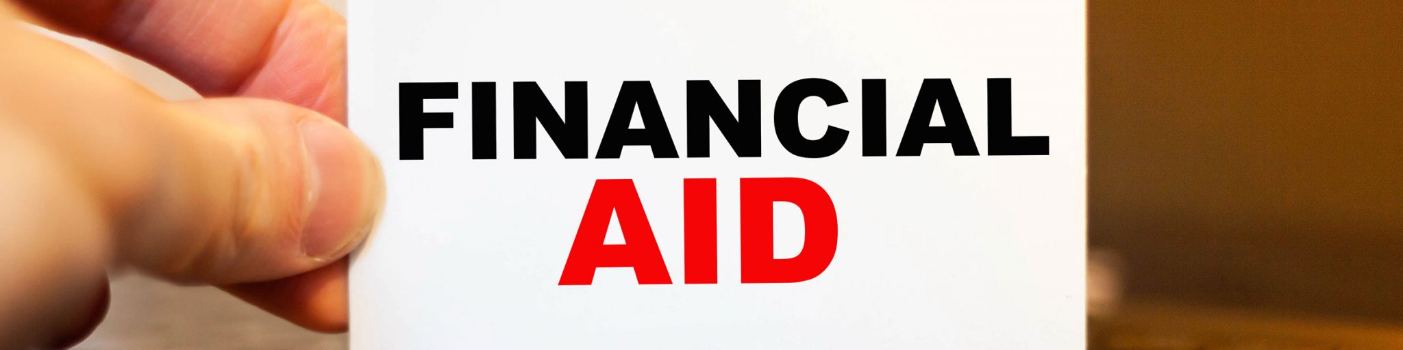 Financial Aid Sign being held by man's hand